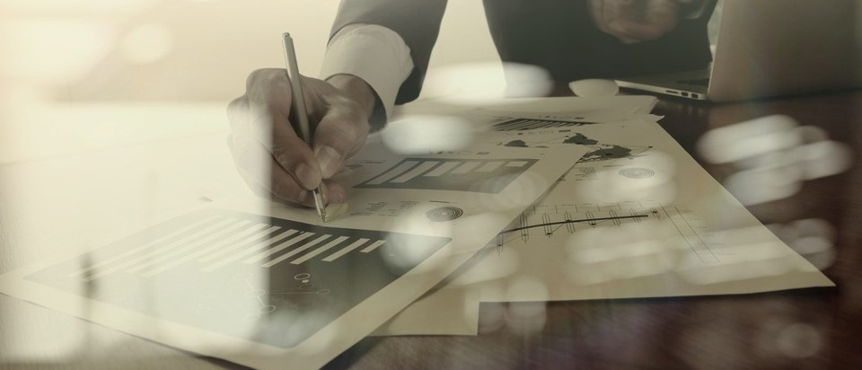 business documents on office table with smart phone and digital tablet and graph business diagram and man working in the background-1